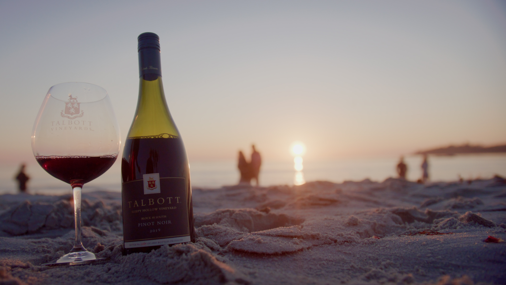 Talbott Pinot Noir bottle on the beach at sunset