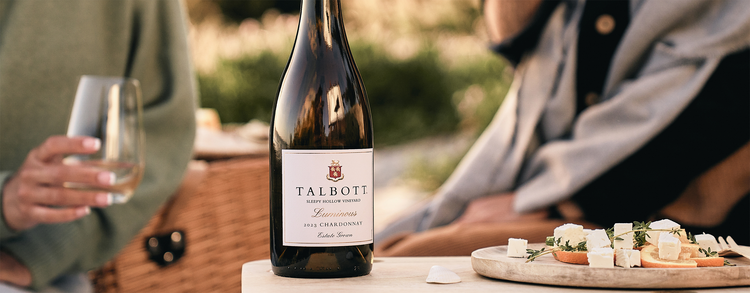 People gathered, enjoying Luminous Chardonnay.