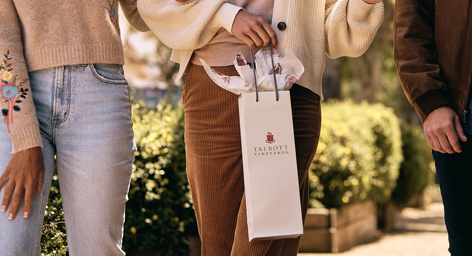 Gift Guide person holding a Talbott gift bag.