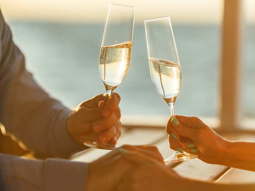 A couple holding hands and drinking Talbott wines.